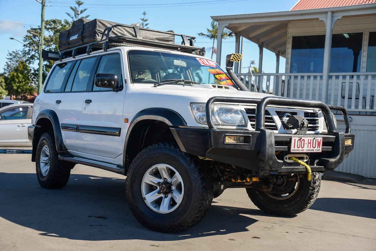 White Nissan Patrol Y61 4x4 wagon fitted with bull bar, winch, snorkel and roof rack — the Patrol platform used for high-horsepower 600+ HP turbo builds, sourced to order by Seaver Associates Inc.