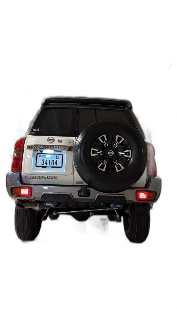 White Nissan Patrol sport build with rear-mounted spare off-road wheel, back view